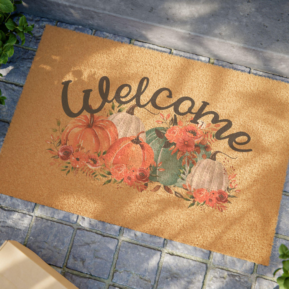 Autumn coir doormat featuring painted pumpkins florals and hand lettered Welcome lettering on a warm tan background from Drizzle and Tizzle for Home and beyond
