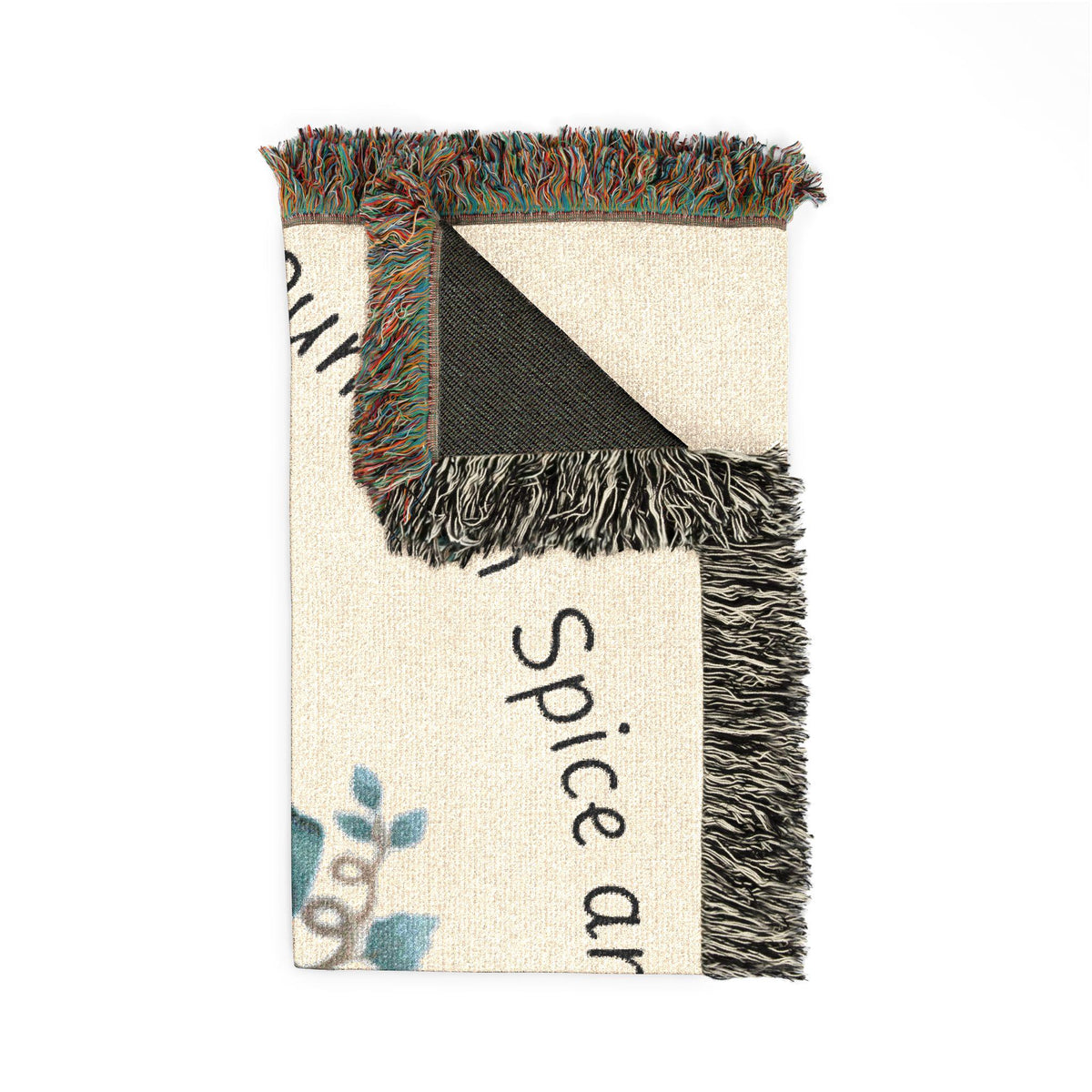 Folded woven autumn throw blanket with cream black and multicolor geometric patterns and long fringe from Drizzle and Tizzle Home and beyond