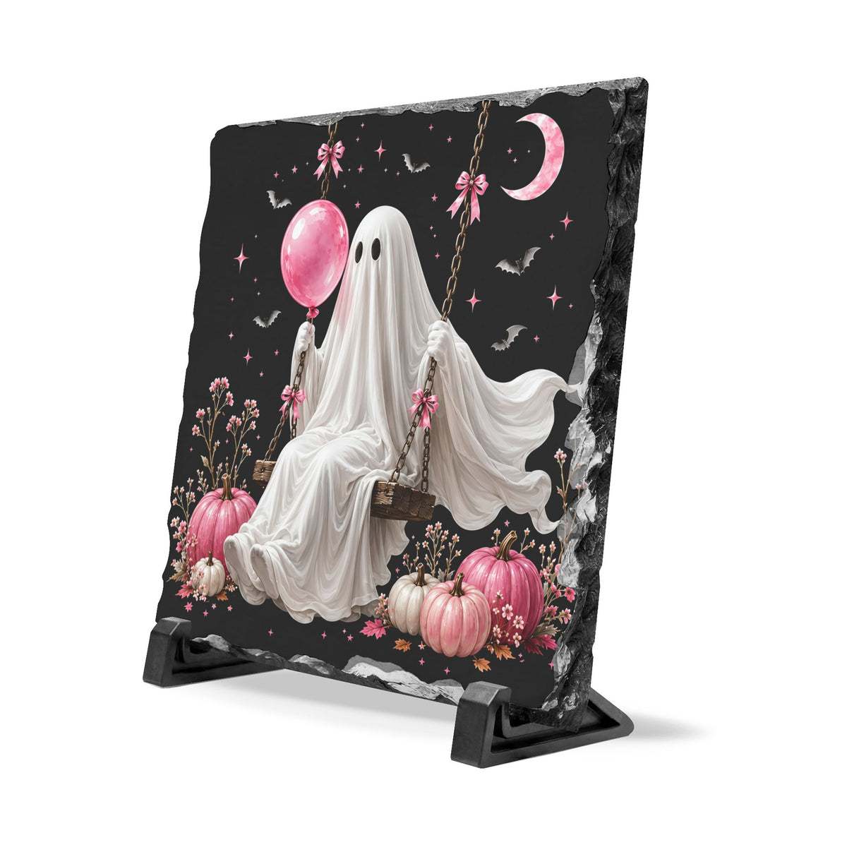 Handcrafted slate Halloween plaque featuring a white ghost on a swing surrounded by pink pumpkins flowers bats and a crescent moon for seasonal home decor