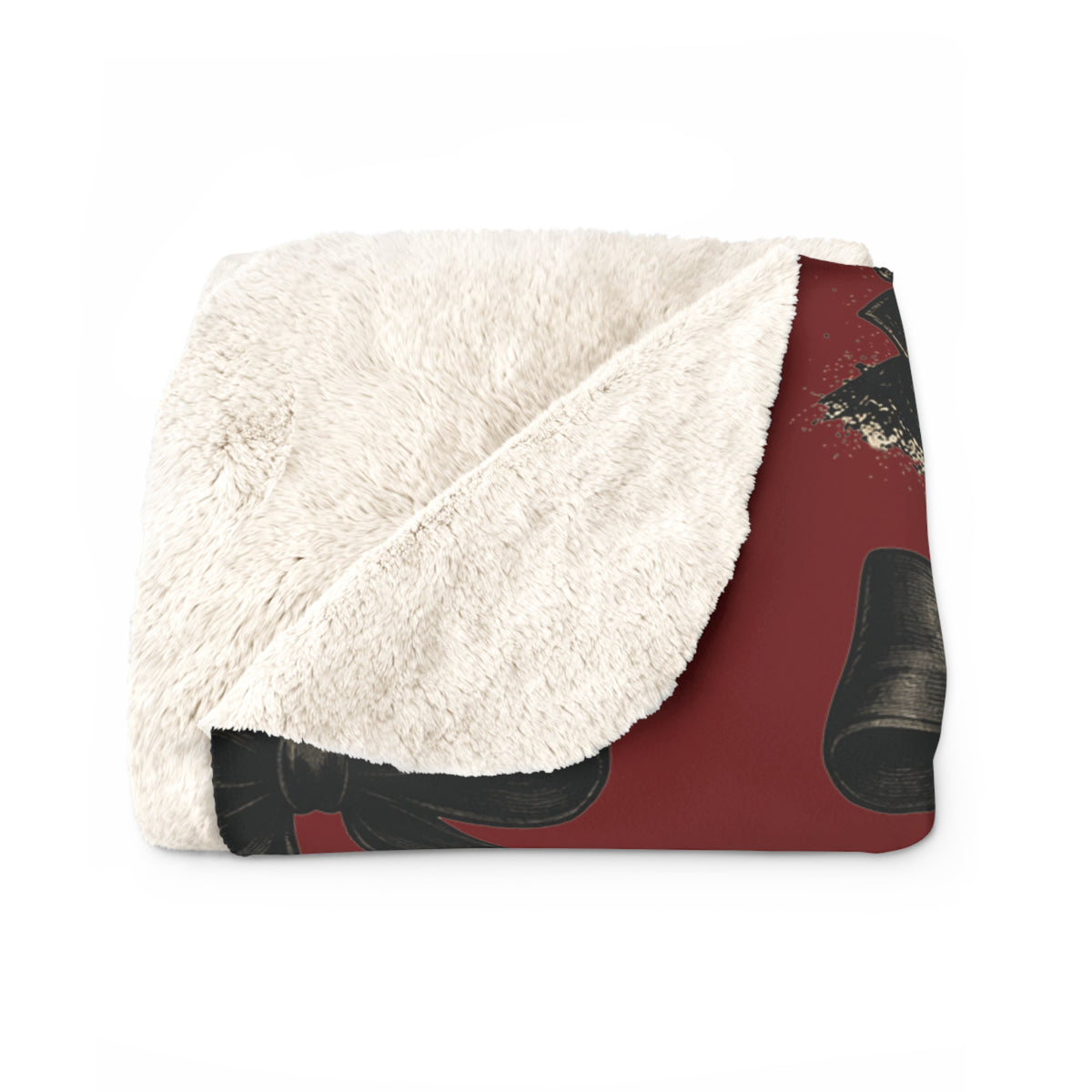 Folded red horror inspired sherpa blanket with a soft cream plush lining and dark graphic mask details for cozy seasonal home decor