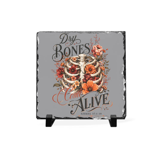 Natural slate decor plaque with a ribcage surrounded by orange flowers and autumn leaves plus Dry Bones Come Alive lettering