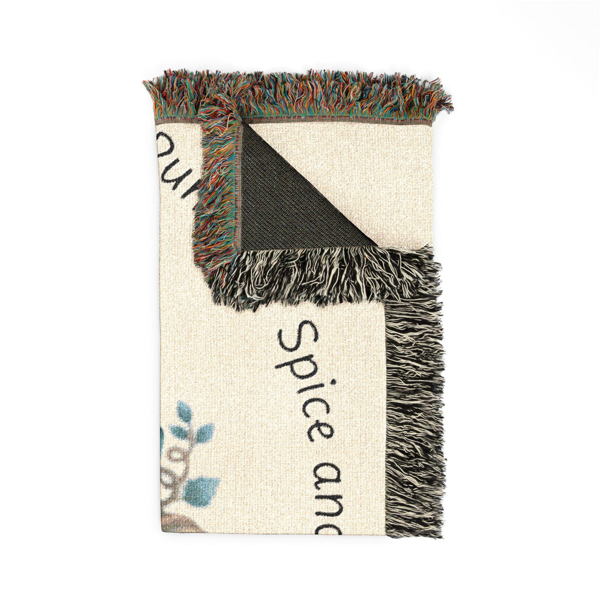 Fringed woven autumn throw blanket with black and cream geometric patchwork and partial spice and lettering for seasonal home decor