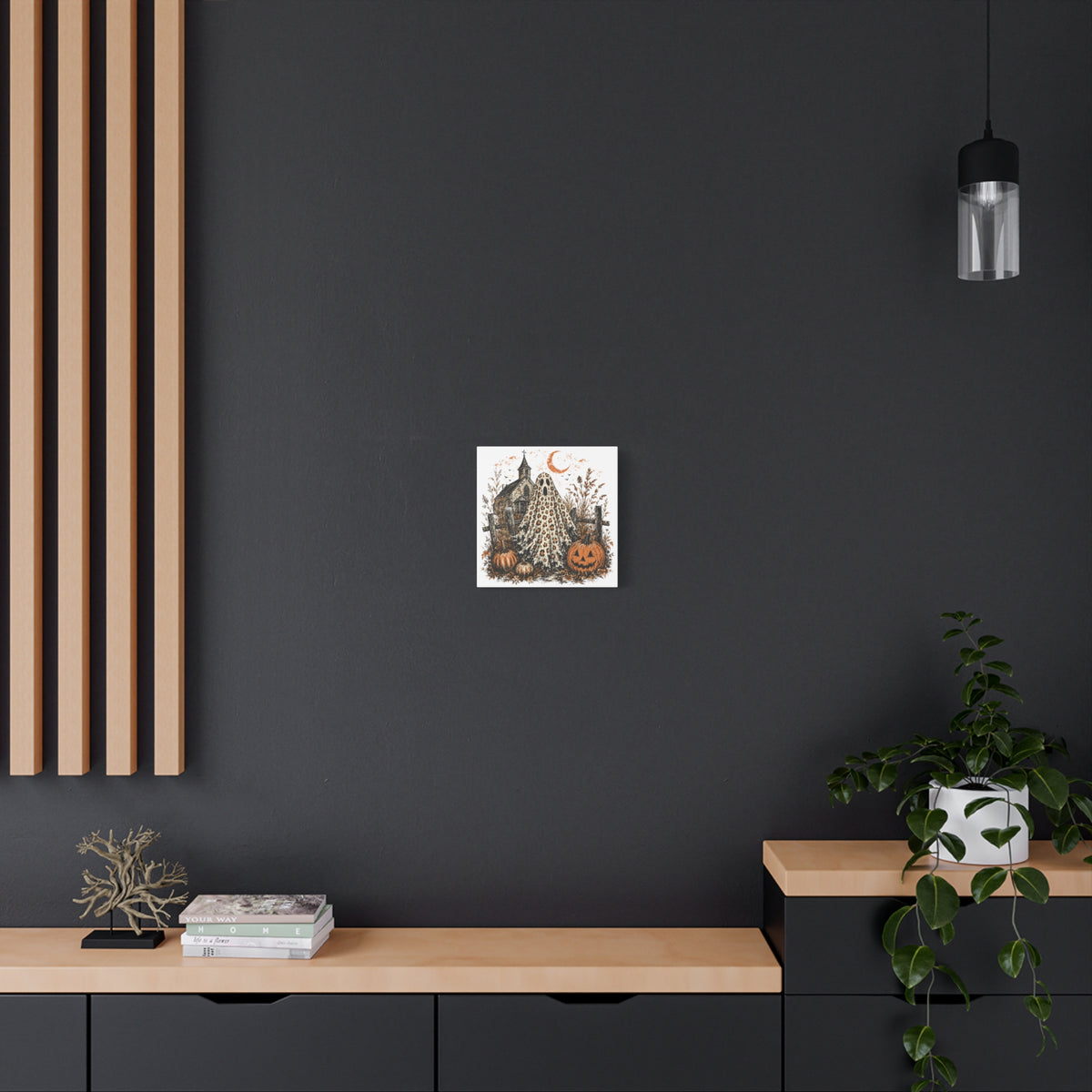 Small Halloween canvas wall art featuring a leopard print ghost with pumpkins and a spooky church beneath a crescent moon on a dark wall by Printify