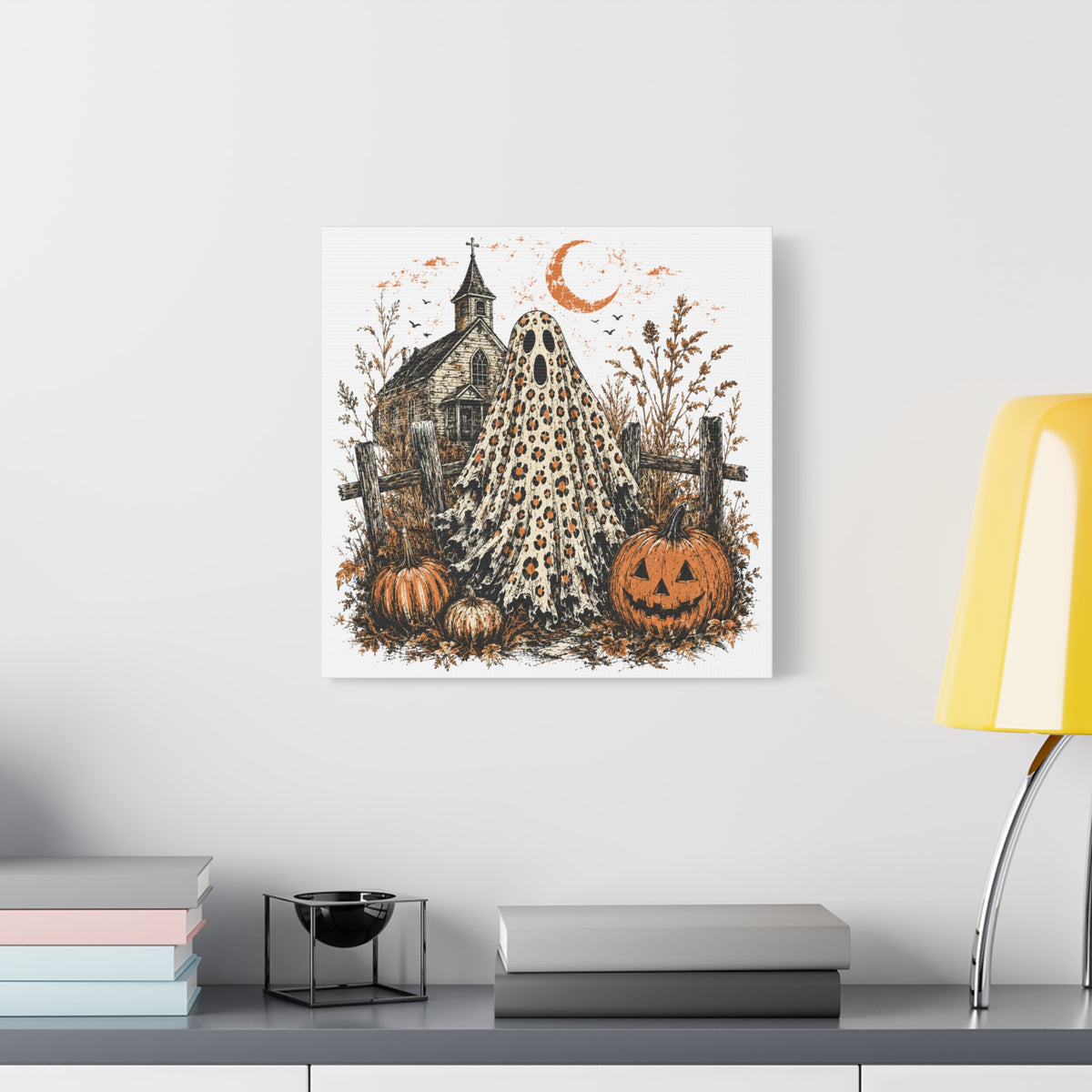 Vintage Halloween canvas wall art featuring a leopard print ghost pumpkins an old church and a crescent moon displayed above a modern console table