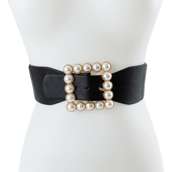 Black wide vegan leather belt with a square buckle framed by faux pearls displayed on a mannequin from BCNY BOUTIQUE Bags and Belts collection