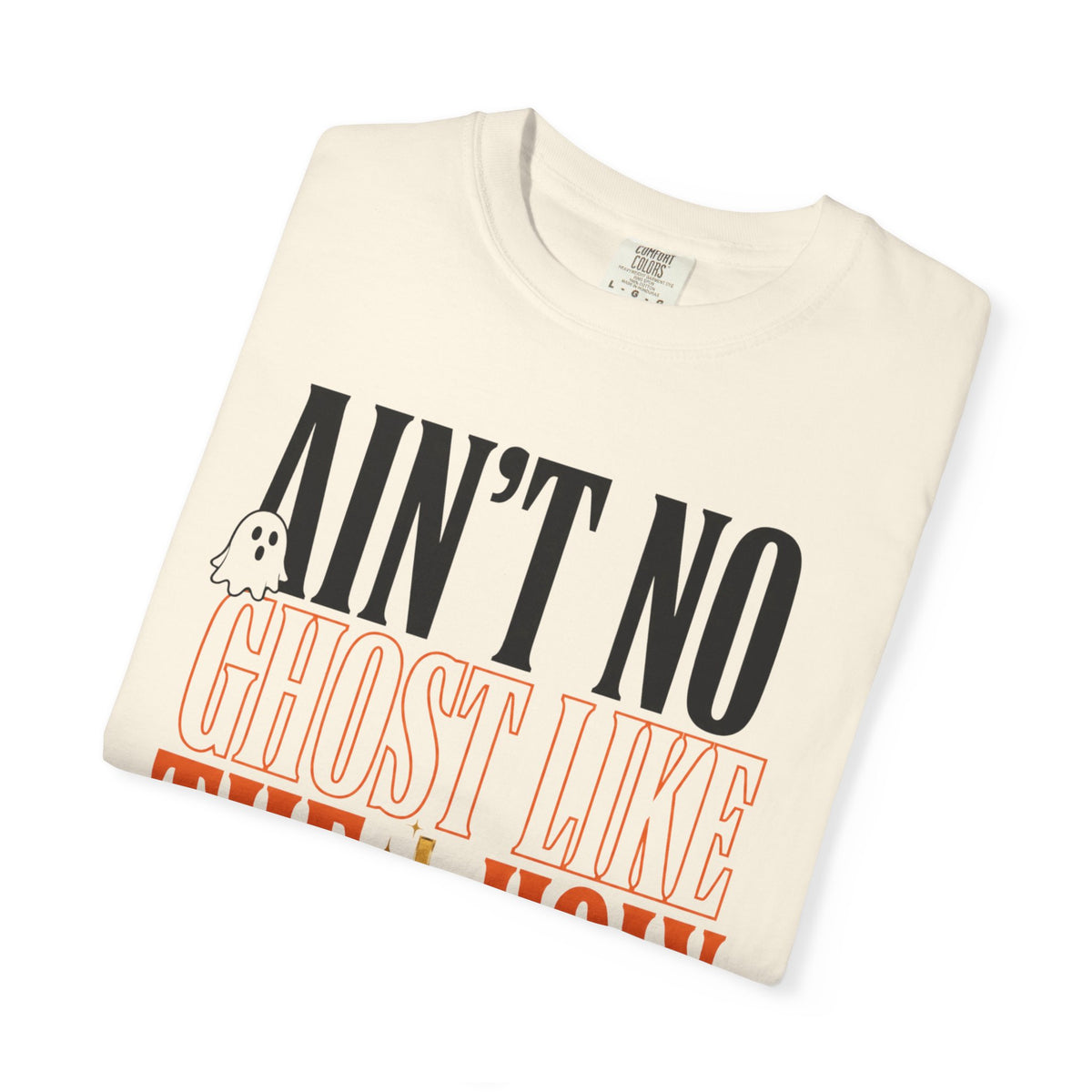 Folded cream graphic T shirt featuring bold black and orange text reading Ain't No Ghost Like the Holy Ghost with a small ghost illustration