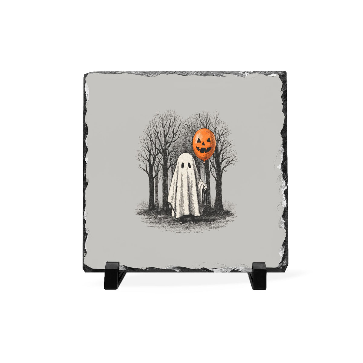 Gray slate Halloween desk plaque featuring a sheet ghost holding an orange pumpkin balloon among bare trees with a rustic chiseled edge
