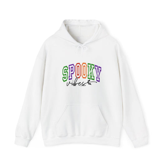 White pullover hoodie with colorful collegiate SPOOKY lettering and black Vibes script on the front plus a roomy kangaroo pocket for cozy seasonal style