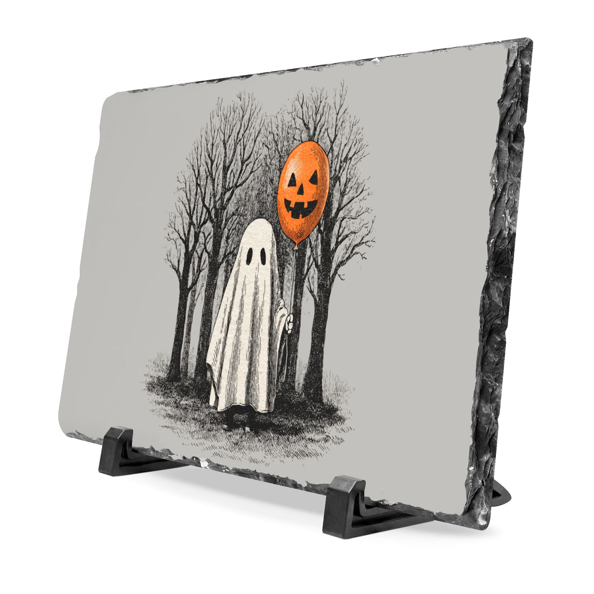 Hand cut slate desk plaque featuring a sheet ghost holding an orange pumpkin balloon in a spooky bare tree scene with a rustic display stand