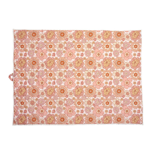 Pink floral quilted picnic blanket with a repeating botanical pattern and water repellent cotton surface for outdoor family adventures