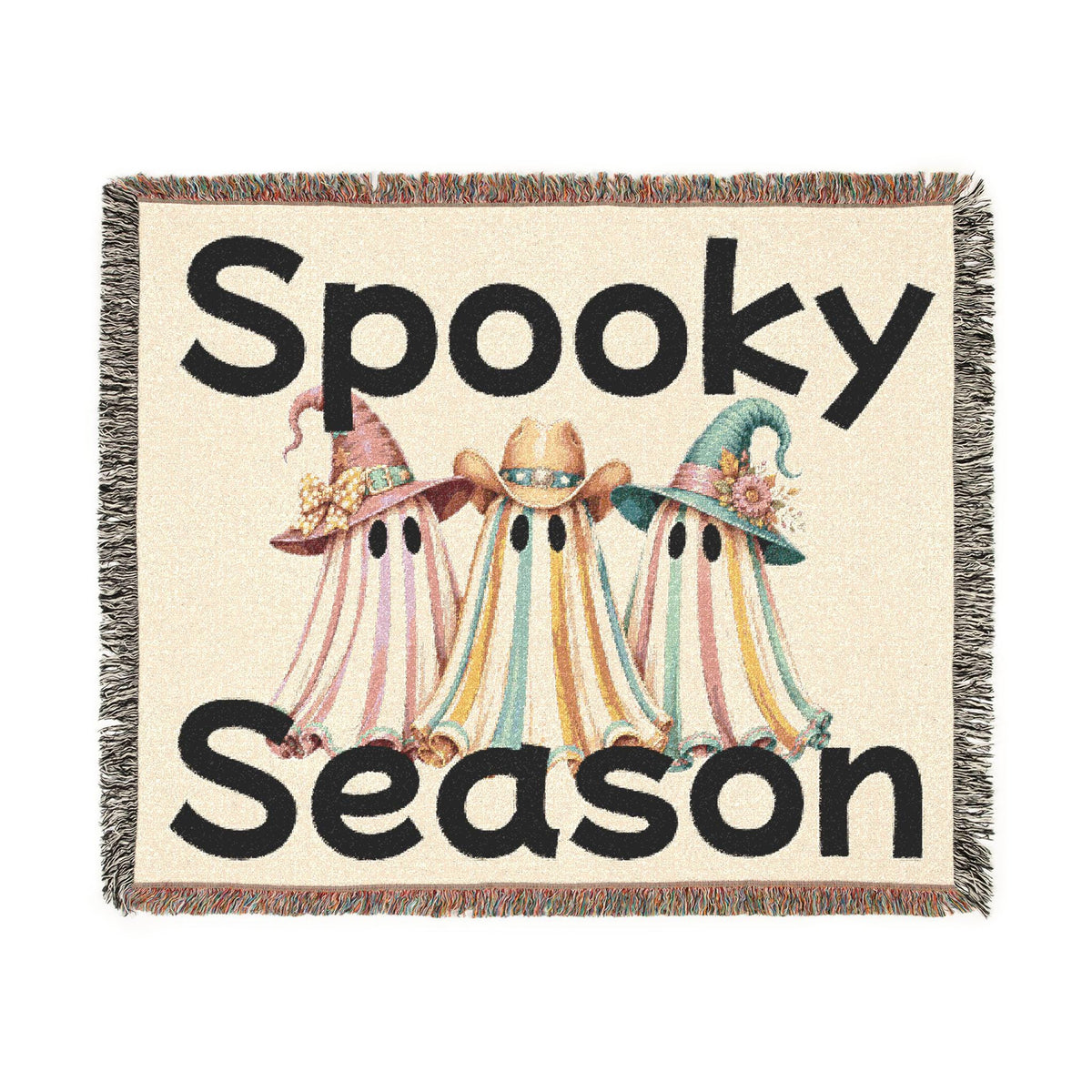 Spooky Season woven throw blanket featuring three colorful ghosts in witch hats with fringed edges, from Drizzle and Tizzle Home and beyond collection