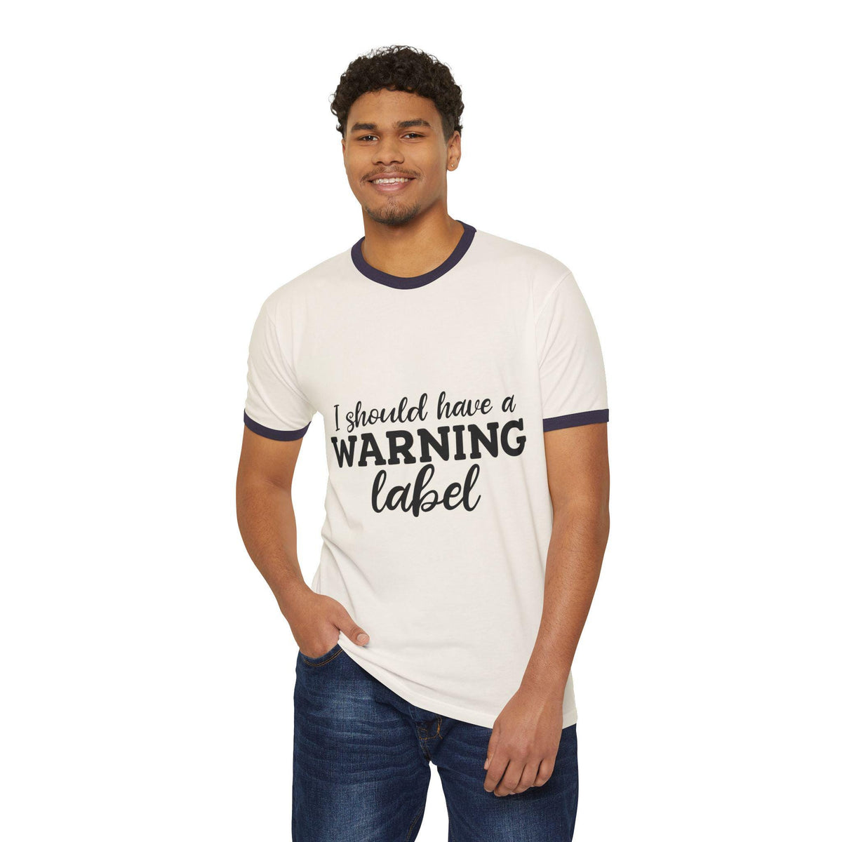 Smiling model wearing a vintage white ringer tee with navy trim and a playful I should have a warning label graphic on the front