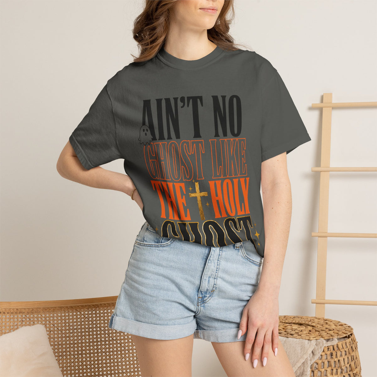 Womens charcoal graphic tee featuring bold vintage lettering with an uplifting Holy Ghost message styled with light denim shorts for a casual summer look