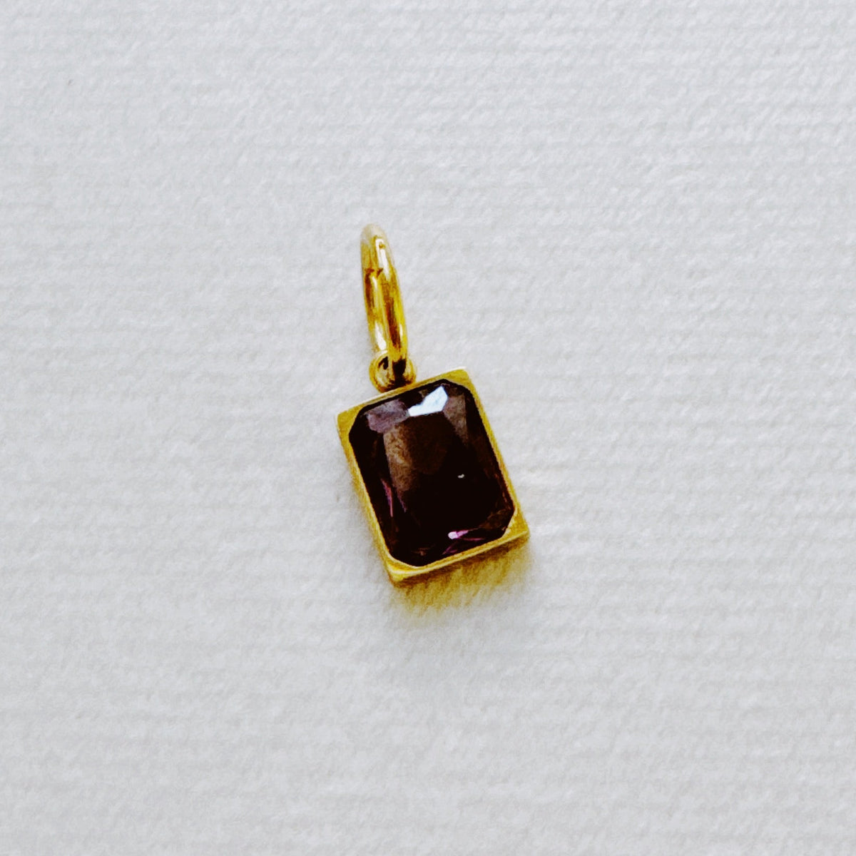 Gold rectangular dark birthstone pendant with a faceted stone from Ellison and Young Best Sellers Jewelry collection for women's jewelry