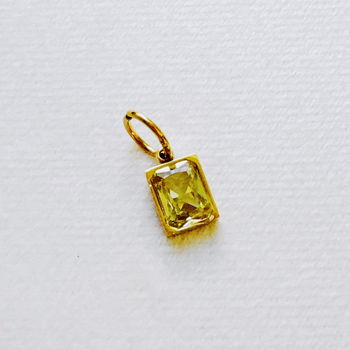 Gold birthstone pendant with a faceted rectangular yellow gemstone and hoop bail from Ellison and Young for womens jewelry and Best Sellers Jewelry