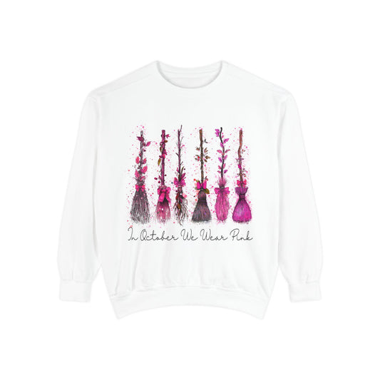White crewneck sweatshirt with five hand painted pink floral stems and the message In October We Wear Pink for breast cancer awareness fashion