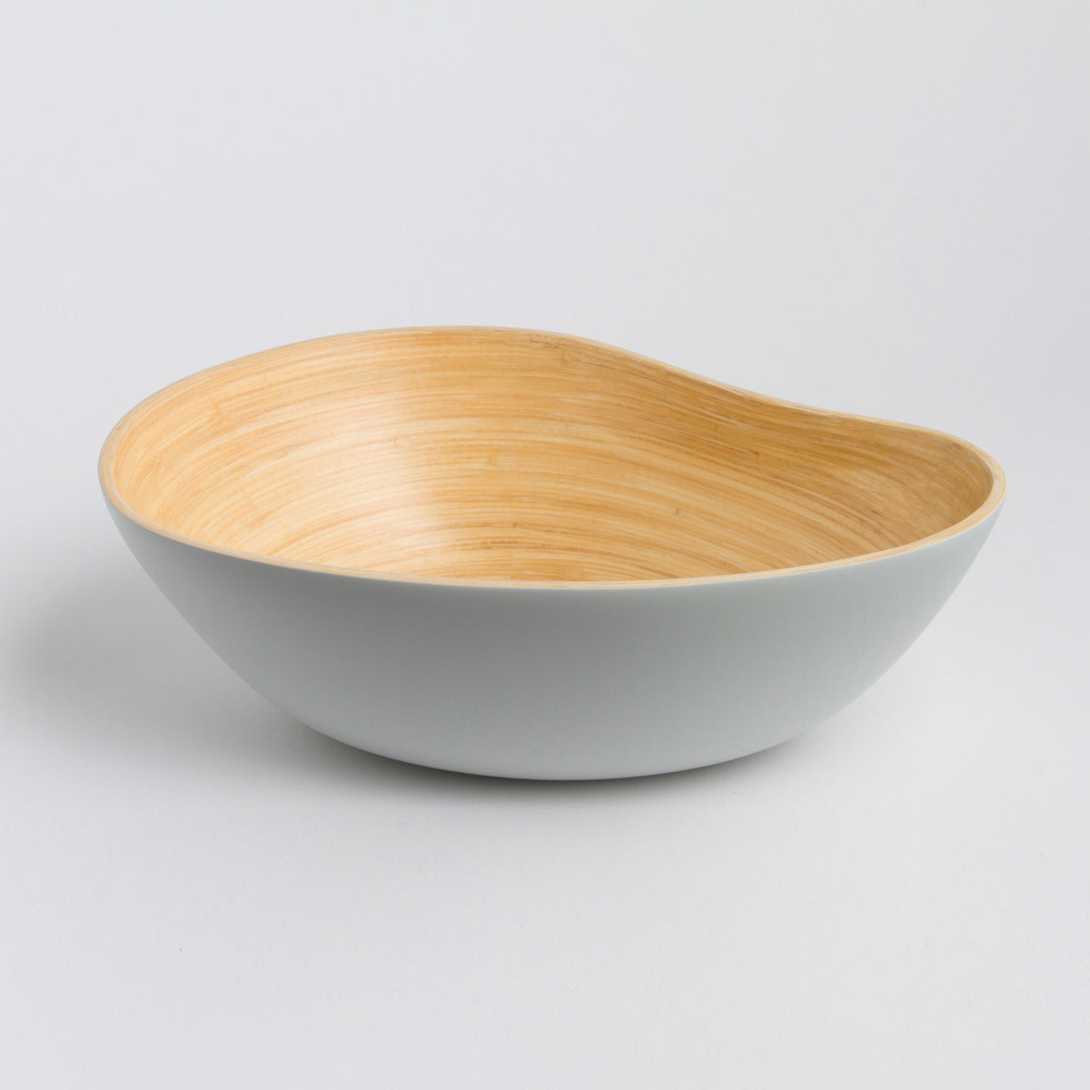 Asymmetrical mango shaped bamboo serving bowl with a smooth gray exterior and natural wood interior for serving or home decor from DC-Bibol in Home and beyond