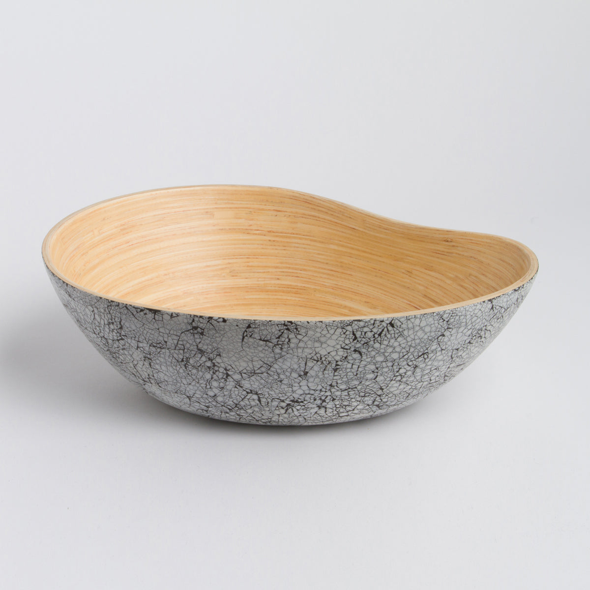 Asymmetrical mango shaped bamboo serving bowl with a natural wood interior and textured gray exterior for stylish home decor from DC Bibol in Home and beyond