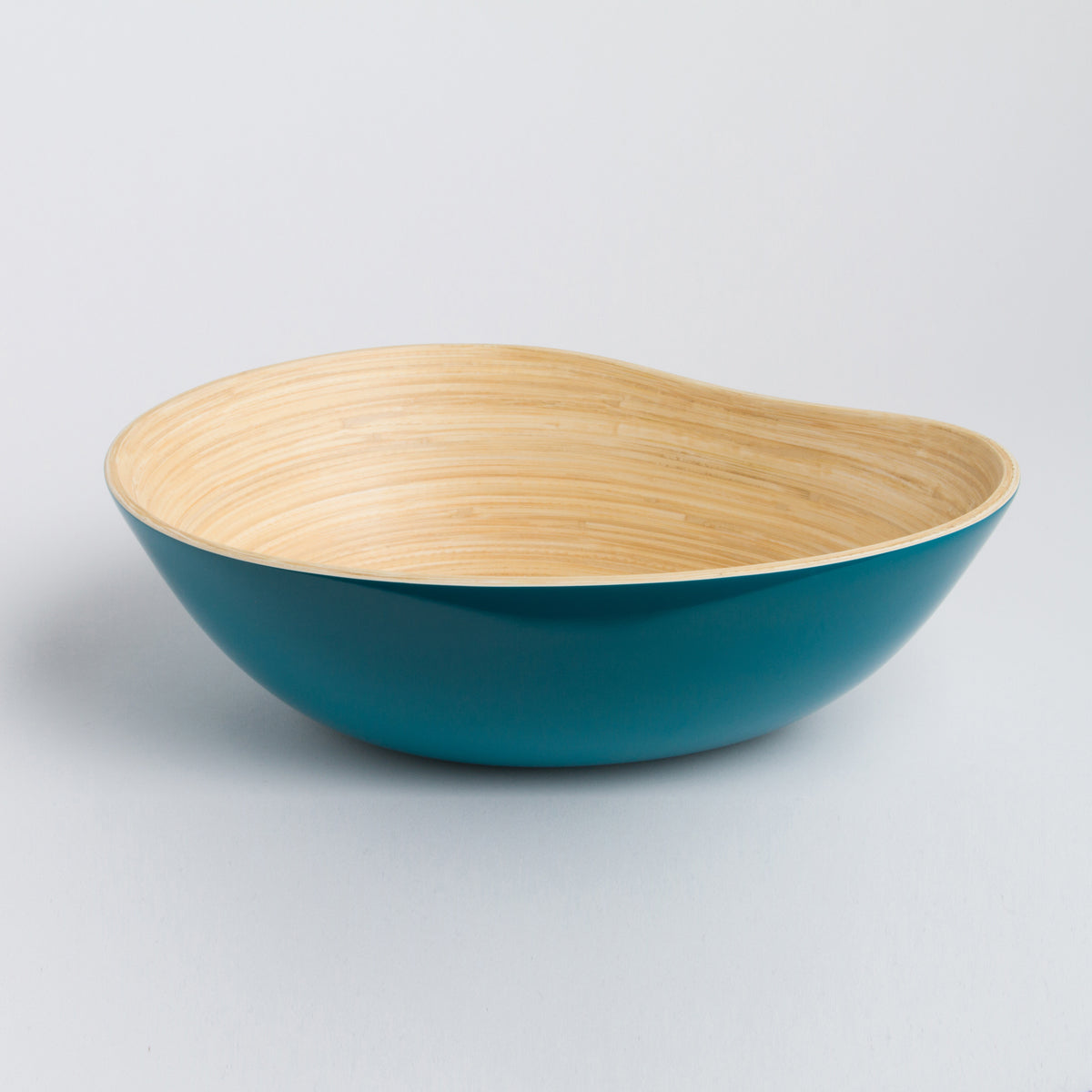 Teal asymmetrical bamboo serving bowl with a natural wood interior for home decor from DC Bibol in the Home and beyond collection