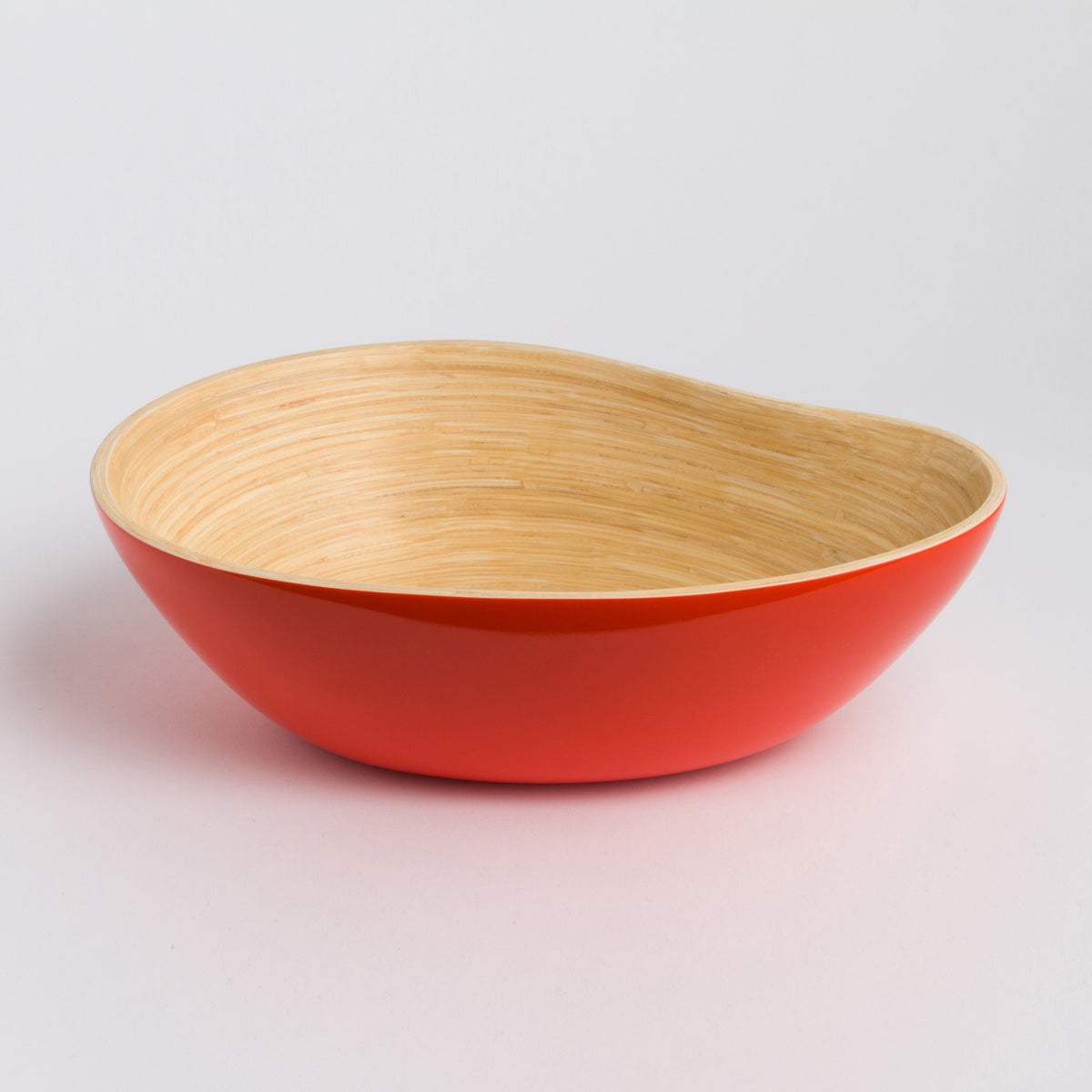 Red and natural bamboo serving bowl with a graceful asymmetrical shape for serving or home decor from DC Bibol in the Home and beyond collection