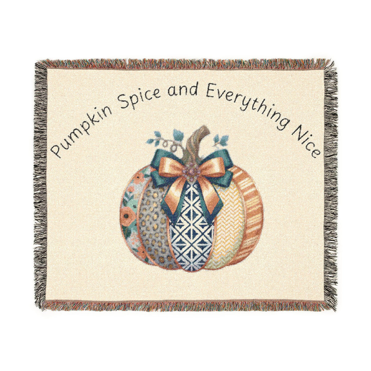 Cream woven autumn throw blanket with colorful patterned pumpkins tied with a bow, fringed edges, and Pumpkin Spice and Everything Nice lettering