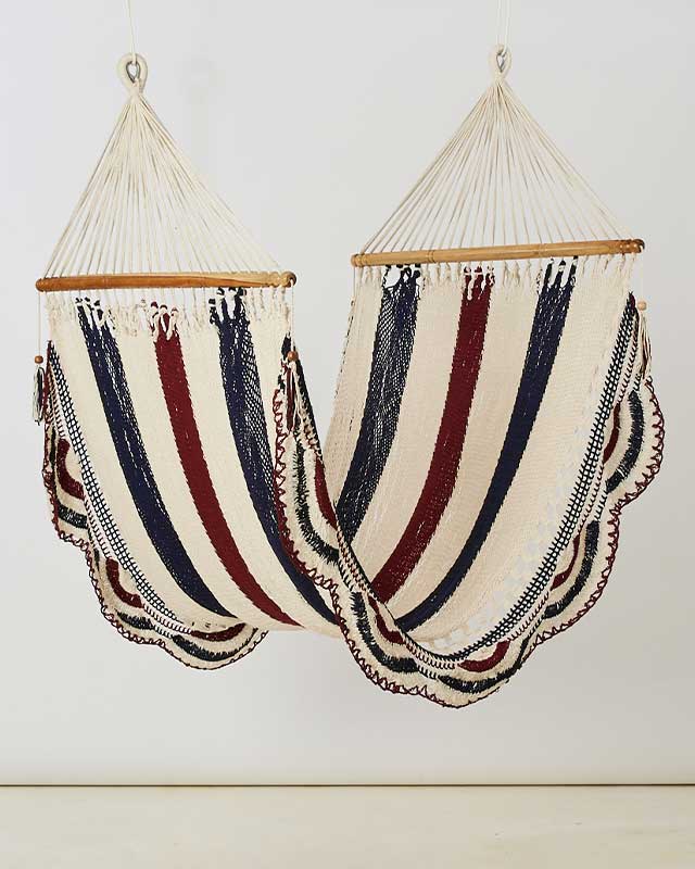 Two striped cotton hammocks in cream navy and burgundy hang side by side with scalloped edges. Handmade in Nicaragua by DC-Love for Nica for stylish home decor.