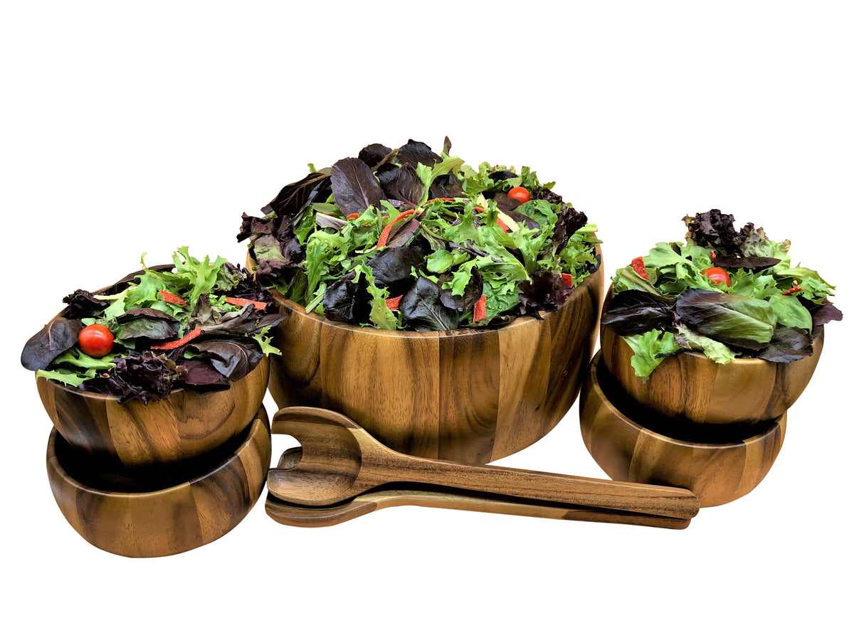 Seven piece wooden salad serving set with large bowl four individual bowls and serving utensils filled with fresh greens from DC-Kalmar Home for Home and beyond