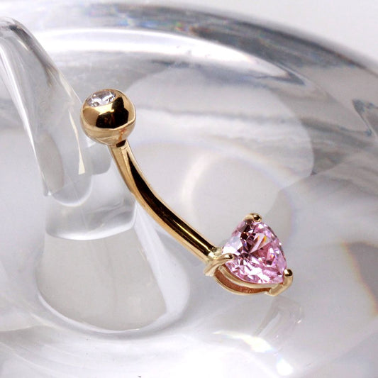14kt gold navel ring featuring a prong set pink heart shaped cubic zirconia and polished gold ball detail from Fashion Hut Jewelry in the Jewelry collection