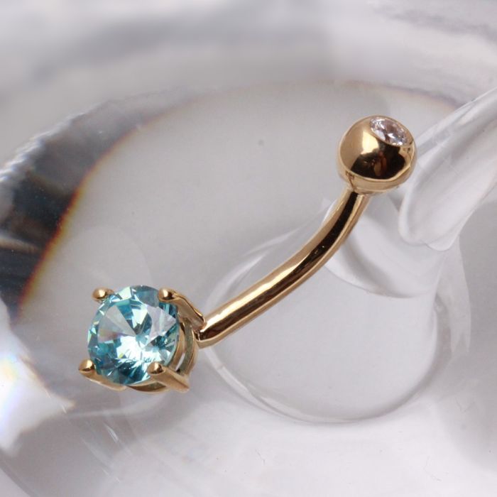 14 karat yellow gold navel ring with a prong set round blue cubic zirconia and polished top ball by Fashion Hut Jewelry from the Jewelry collection